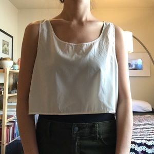 Mid length loose tank in off white faux silk.
